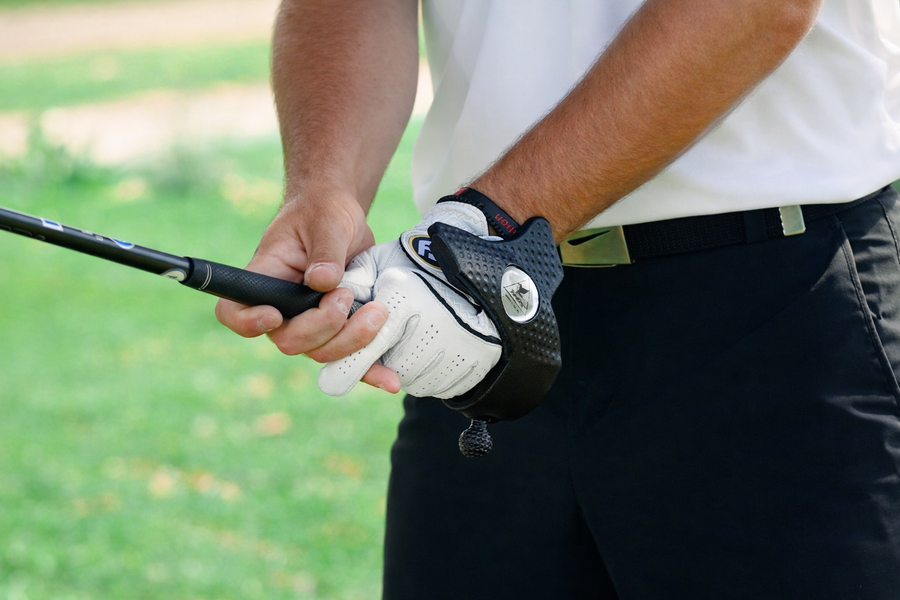 Close-up of hands gripping a club with ZoneGrip fitted on the lead hand