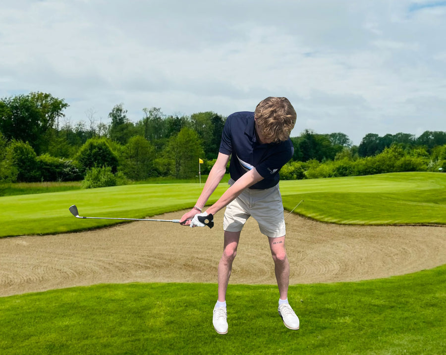 Golfer starting the takeaway with hands quiet and connected