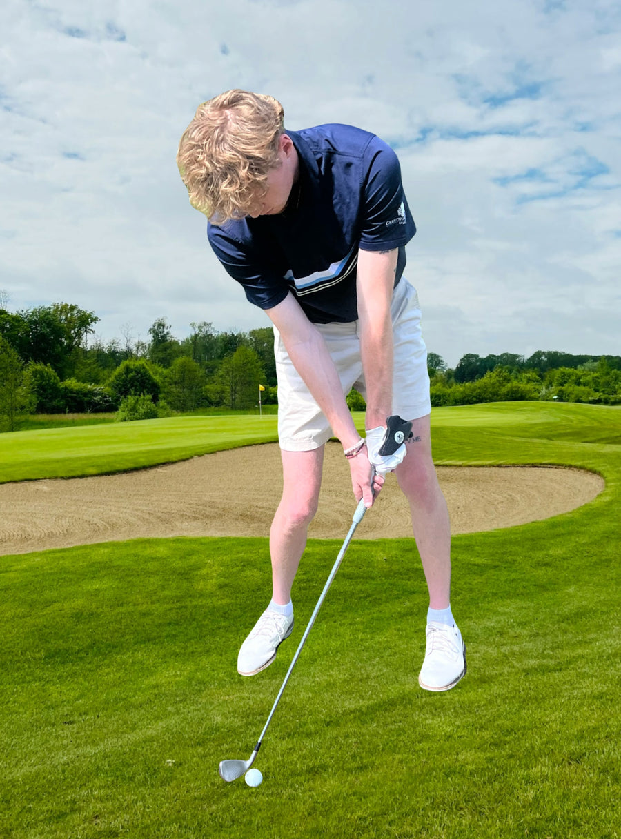 Golfer set up for solid contact with proper hand and wrist position