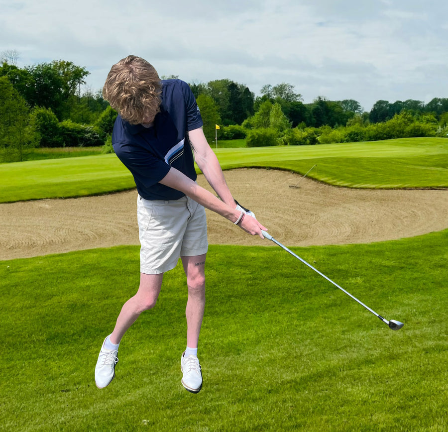 Golfer rotating powerfully through the ball into the follow-through